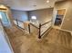 Upstairs hallway with carpet, wooden banister, and laundry room, offering functionality and style at 9052 Pine Mission Ave, Las Vegas, NV 89143