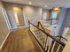 Upstairs hallway with carpet and white banister overlooking the staircase at 9052 Pine Mission Ave, Las Vegas, NV 89143