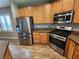 Kitchen featuring stainless steel appliances and wooden cabinetry at 9052 Pine Mission Ave, Las Vegas, NV 89143