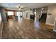 Large living room with fireplace and hardwood floors adjacent to the kitchen and stairwell at 9052 Pine Mission Ave, Las Vegas, NV 89143