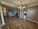 Open living space with wood-look flooring, large windows, and a view of the staircase at 9052 Pine Mission Ave, Las Vegas, NV 89143