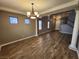 Spacious living room featuring hardwood floors, neutral paint, chandelier, and staircase at 9052 Pine Mission Ave, Las Vegas, NV 89143