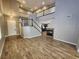 Spacious living room with fireplace, wood-look flooring, and staircase to the upper level at 9052 Pine Mission Ave, Las Vegas, NV 89143