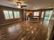 Open-concept living space featuring hardwood floors and view of the kitchen and backyard at 9052 Pine Mission Ave, Las Vegas, NV 89143