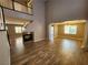 Open-concept living room boasting high ceilings, a fireplace, and wood-look flooring at 9052 Pine Mission Ave, Las Vegas, NV 89143