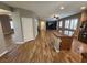 Open-concept living room with wood floors, ceiling fan, and view to kitchen with island at 9052 Pine Mission Ave, Las Vegas, NV 89143
