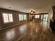 Open-concept living space featuring hardwood floors, fireplace, and view of the kitchen at 9052 Pine Mission Ave, Las Vegas, NV 89143