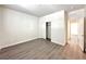 Bright bedroom featuring wood-look floors and a closet for ample storage space at 907 Gallery Course Dr, Las Vegas, NV 89148