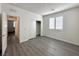 Neutral bedroom featuring wood-look floors, window with shutter and closet at 907 Gallery Course Dr, Las Vegas, NV 89148