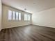 Bright bedroom features wood-look flooring and window shutters at 907 Gallery Course Dr, Las Vegas, NV 89148