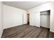 Neutral bedroom featuring wood-look floors and closet with sliding doors at 907 Gallery Course Dr, Las Vegas, NV 89148
