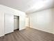 Bedroom with wood-look floors and a closet with sliding doors at 907 Gallery Course Dr, Las Vegas, NV 89148