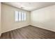 Neutral bedroom featuring wood-look floors, and a window with shutter at 907 Gallery Course Dr, Las Vegas, NV 89148