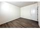 Neutral bedroom featuring wood-look floors, and a white door at 907 Gallery Course Dr, Las Vegas, NV 89148
