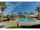 Stunning community pool surrounded by palm trees, ample seating, and a fun splash park at 907 Gallery Course Dr, Las Vegas, NV 89148