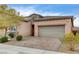 Attractive home with a two-car garage, brick driveway, stone accents, and low-maintenance landscaping at 907 Gallery Course Dr, Las Vegas, NV 89148