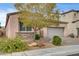 Inviting single-story home with a well-maintained front yard, desert landscaping, and brick driveway at 907 Gallery Course Dr, Las Vegas, NV 89148