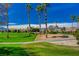 Beautiful green golf course surrounded by palm trees and mountain views under a bright blue sky at 907 Gallery Course Dr, Las Vegas, NV 89148