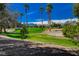 Lush green spaces with palm trees and desert mountains create a serene and inviting outdoor environment at 907 Gallery Course Dr, Las Vegas, NV 89148