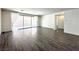 Bright living room with sliding glass door and wood-look tile floors at 907 Gallery Course Dr, Las Vegas, NV 89148
