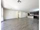 Spacious living room featuring sleek, modern wood-look flooring, neutral walls, and ample natural light at 907 Gallery Course Dr, Las Vegas, NV 89148