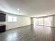 Open-concept living room features wood-look tile flooring and natural light at 907 Gallery Course Dr, Las Vegas, NV 89148
