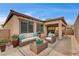 Charming outdoor patio with stylish furniture and landscaping for relaxing entertainment at 907 Gallery Course Dr, Las Vegas, NV 89148
