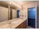 Bright bathroom with double sinks, a large mirror, and a neutral color scheme at 9155 Harvest Homes St, Las Vegas, NV 89123