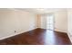 An empty bedroom with hardwood floors and sliding doors leading to a balcony or patio area at 9155 Harvest Homes St, Las Vegas, NV 89123