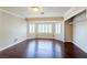 Spacious bedroom featuring hardwood floors, a bay window, and walk-in closet space at 9155 Harvest Homes St, Las Vegas, NV 89123