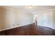 Empty bedroom with hardwood floors, white trim, ample natural light, and two doors leading to other rooms at 9155 Harvest Homes St, Las Vegas, NV 89123