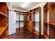 Walk-in closet with wood floors and built-in shelves at 9155 Harvest Homes St, Las Vegas, NV 89123