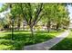 A scenic community park featuring lush greenery and inviting walkway at 9155 Harvest Homes St, Las Vegas, NV 89123