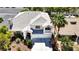 Elegant two-story home featuring a balcony, 3-car garage, and mature landscaping at 9155 Harvest Homes St, Las Vegas, NV 89123