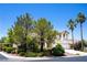 Lovely home featuring a well-maintained front yard, mature trees, and a three-car garage, creating a welcoming atmosphere at 9155 Harvest Homes St, Las Vegas, NV 89123