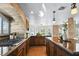 Spacious kitchen featuring dark wood cabinets, granite countertops, stainless steel appliances, and stone backsplash at 9155 Harvest Homes St, Las Vegas, NV 89123