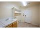 Functional laundry room with sink, storage shelves, and access to the outside at 9155 Harvest Homes St, Las Vegas, NV 89123