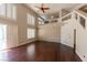 Large living room boasting dark hardwood floors, fireplace, high ceilings, clerestory windows, and lots of natural light at 9155 Harvest Homes St, Las Vegas, NV 89123
