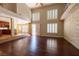 Open-concept living area with hardwood floors, stone accent wall, and shuttered windows for natural light at 9155 Harvest Homes St, Las Vegas, NV 89123