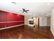 Bright living room featuring hardwood floors, fireplace, and a pop of color on the accent wall at 9155 Harvest Homes St, Las Vegas, NV 89123