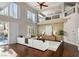 Bright open living room with clerestory windows, a white sectional, and hardwood floors leading to a pool at 9155 Harvest Homes St, Las Vegas, NV 89123