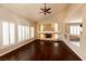 Bright living room boasts hardwood floors, fireplace, and vaulted ceilings with fan at 9155 Harvest Homes St, Las Vegas, NV 89123