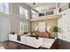Stylish living room with high ceilings, hardwood floors, and large windows with white shutters at 9155 Harvest Homes St, Las Vegas, NV 89123