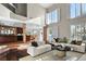 Bright, open-concept living room with hardwood floors, a large white sectional, and lots of natural light at 9155 Harvest Homes St, Las Vegas, NV 89123