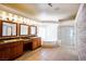Large main bathroom featuring double vanity, soaking tub, glass enclosed shower and travertine tile floors at 9155 Harvest Homes St, Las Vegas, NV 89123