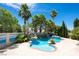 Resort-style pool area featuring rock waterfalls, lush landscaping, and privacy, creating a serene backyard retreat at 9155 Harvest Homes St, Las Vegas, NV 89123