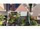 Aerial shot of a home's backyard, which includes palm trees, desert landscaping, and a covered patio at 9272 W Viking Rd, Las Vegas, NV 89147