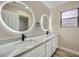 Bright bathroom features dual sinks, white cabinets, quartz counters, and decorative circular mirrors with a shower in the background at 9272 W Viking Rd, Las Vegas, NV 89147