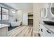 Contemporary bathroom featuring a soaking tub, walk-in shower, dual vanity, and spacious closet at 9272 W Viking Rd, Las Vegas, NV 89147