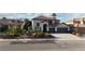 Charming stucco home boasts a red tile roof, two-car garage and low maintenance desert landscaping at 9272 W Viking Rd, Las Vegas, NV 89147